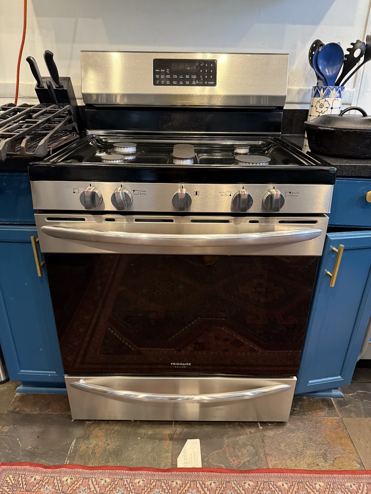 The Appliance Gals — stainless Frigidaire Gallery gas range serviced in an Atlanta customer kitchen with blue cabinets